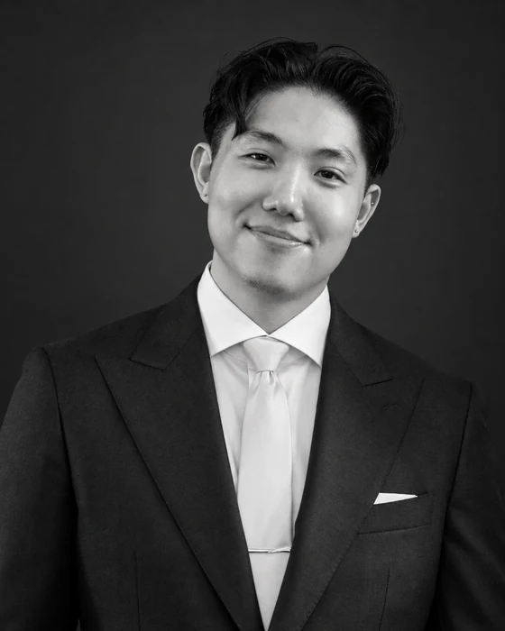 Black-and-white portrait of Daniel Choi in a suit
